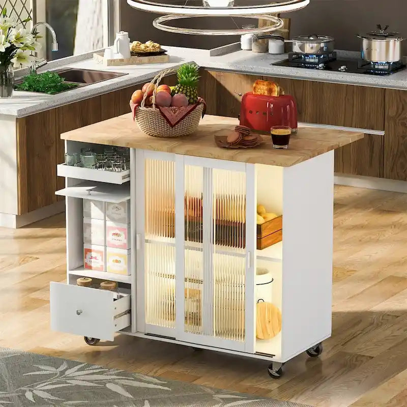 Velký kuchyňský ostrůvek na kolečkách s rozkládací deskou, skleněnými dvířky, LED osvětlením a 2 zásuvkami